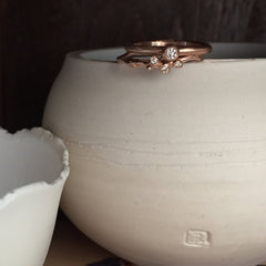 Small, single branch ring with 3 diamond buds; shown in rose gold and shown with small pod ring with larger center diamond