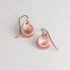 Small, stylized rose petal earring on wire; shown in rose gold